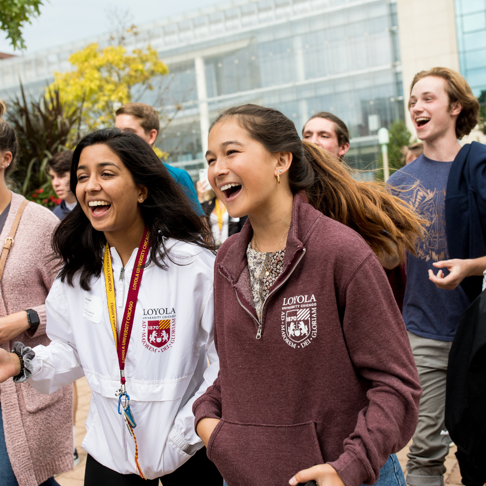 Loyola University Chicago students walking and laughing outside Loyola University Chicago students walking and laughing outside